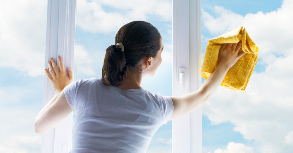 woman cleaning window glass